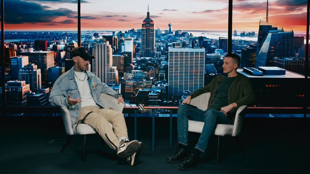 Two-hander interview on a sunset skyline LED world